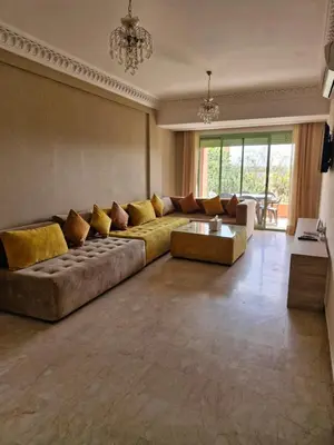a large living room with a couch and a table at Appartement babylon 2 marrakech in Marrakech