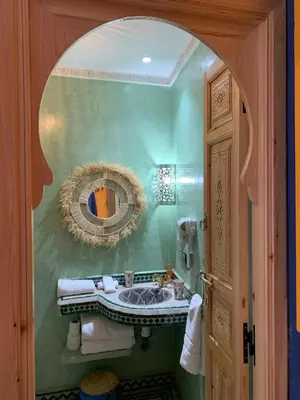 a bathroom with a sink and a mirror at Riad SunSet Marrakech in Marrakech
