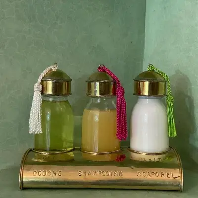 two glass bottles of honey on a shelf at Riad SunSet Marrakech in Marrakech