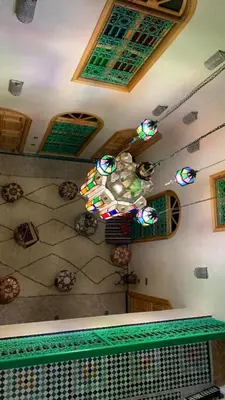 a room with a ceiling with a chandelier at Riad SunSet Marrakech in Marrakech