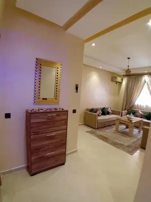 a living room with a dresser and a mirror at Beautiful Apartment Near Airport in Marrakech