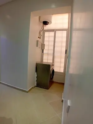 a room with a window and a washing machine at Beautiful Apartment Near Airport in Marrakech