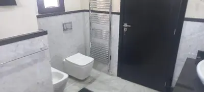 a bathroom with a white toilet and a sink at H Amelkis in Marrakech