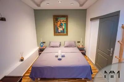 a room with a bed with a painting on the wall at MA Studio in Marrakech