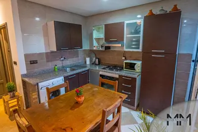 a kitchen with a wooden table and a wooden table sidx sidx sidx at MA Studio in Marrakech