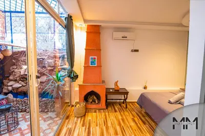 a room with a fireplace in the middle of a room at MA Studio in Marrakech