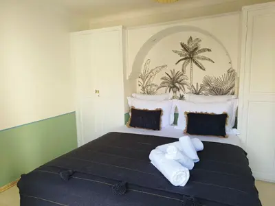 a bedroom with a large bed with white pillows at DarDabakech, proche Jemma el Fna, souk, riad, centre Medina - Maison entière de 2 à 6 personnes, possibilité 3 chambres in Marrakech