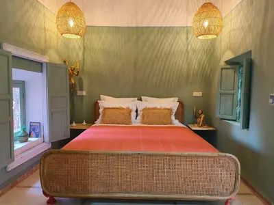 a bedroom with a bed with red sheets and two lamps at DarDabakech, proche Jemma el Fna, souk, riad, centre Medina - Maison entière de 2 à 6 personnes, possibilité 3 chambres in Marrakech