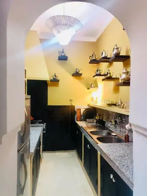 a kitchen with a sink and a kitchen with yellow walls at DarDabakech, proche Jemma el Fna, souk, riad, centre Medina - Maison entière de 2 à 6 personnes, possibilité 3 chambres in Marrakech