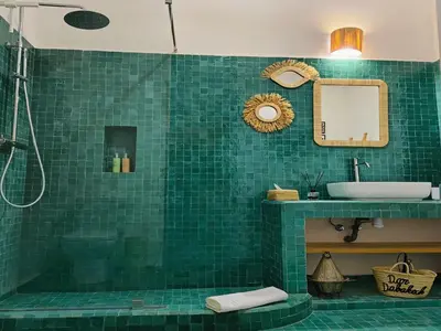 a green tiled bathroom with a sink and a shower at DarDabakech, proche Jemma el Fna, souk, riad, centre Medina - Maison entière de 2 à 6 personnes, possibilité 3 chambres in Marrakech