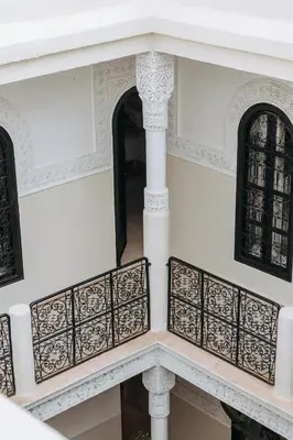 an ornate balcony of a building with black windows at Maison Dar Saada in Marrakech