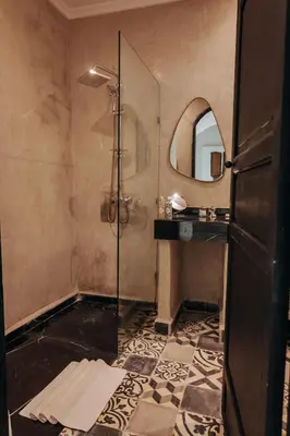 a bathroom with a shower and a mirror at Maison Dar Saada in Marrakech