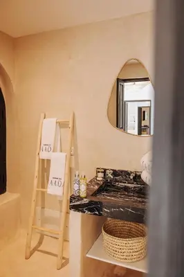 a bathroom with a mirror and a wooden ladder at Maison Dar Saada in Marrakech
