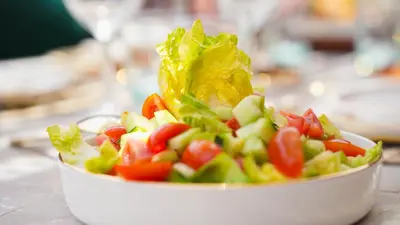 a salad in a white bowl on a table at Riad Anahata Marrakech in Marrakech