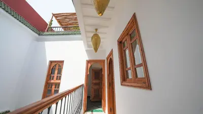 a hallway of a house with a staircase and a door at Riad Anahata Marrakech in Marrakech