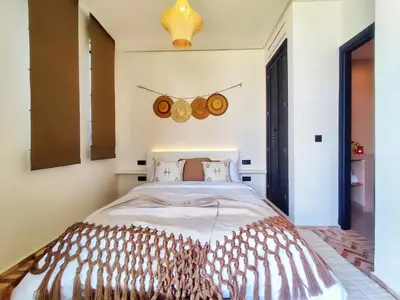 a bedroom with a large bed in a room at Domaine Homa Marrakech in Marrakech