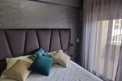 a bedroom with a bed with pillows on it at Luxury city center apartment with swimming pool in Marrakech