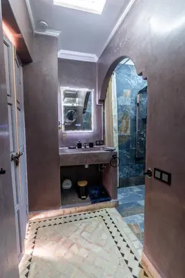a bathroom with a sink and a mirror at Riad LALLA JIHANE in Marrakech