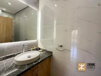 a bathroom with a sink and a mirror at Premium Hivernage Amazigh 2BR Flat - Zayane Homes in Marrakech