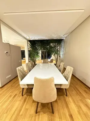 a dining room with a white table and chairs at Villa Marrakech, 15 min from center, Disco, Hammam in Marrakech