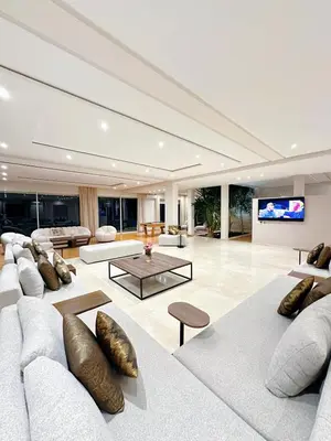 a living room with couches and a flat screen tv at Villa Marrakech, 15 min from center, Disco, Hammam in Marrakech