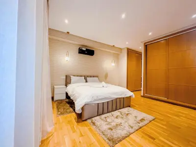 a bedroom with a large bed and a wooden floor at Villa Marrakech, 15 min from center, Disco, Hammam in Marrakech