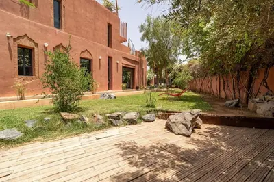 a garden with rocks and a brick building at Designer Villa in La Palmeraie Marrakech in Marrakech