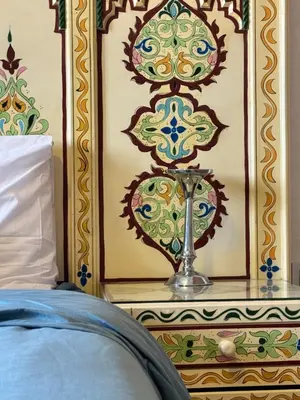 a bedroom with a bed with a trophy on a wall at À 6 min du stade - Résidence avec Piscine, Wifi, Gardien H24 in Marrakech
