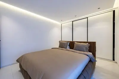 a bedroom with a large bed with windows at Duplex piscine privée chauffée Rooftop in Marrakech
