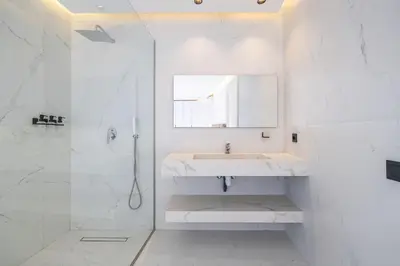 a white bathroom with a sink and a shower at Duplex piscine privée chauffée Rooftop in Marrakech
