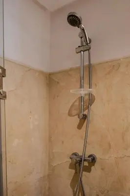 a shower with a shower head in a bathroom at Oasis urbaine - Pearl Garden luxe et confort in Marrakech