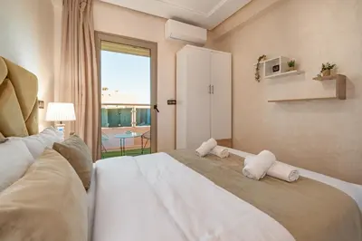 a bedroom with a large bed with towels on it at Cozy Studio with Mountain View in Gueliz, Marrakech in Marrakech