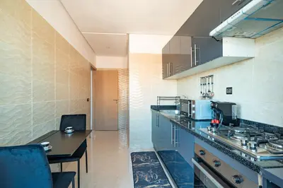 a kitchen with a counter and a table in it at Cozy Studio with Mountain View in Gueliz, Marrakech in Marrakech
