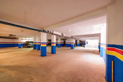 an empty parking garage with blue and colorful columns at Cozy Studio with Mountain View in Gueliz, Marrakech in Marrakech