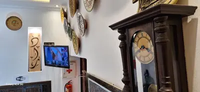a room with a wall with clocks on the wall at Hostel Dar Ben Youssef in Marrakech
