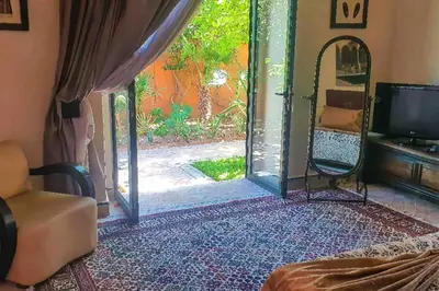 a room with an open door with a tv and a mirror at Villa beldi chic Amelkis golf in Marrakech