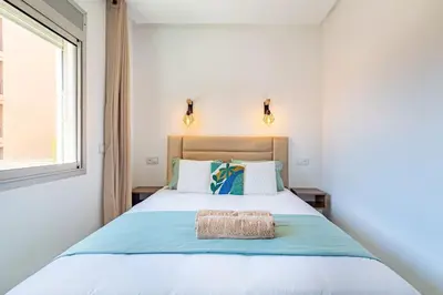 a bedroom with a large bed with a window at New! Chic studio, centrale Guéliz Carré Éden in Marrakech