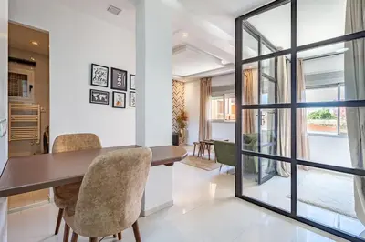 a dining room with a wooden table and chairs at New! Chic studio, centrale Guéliz Carré Éden in Marrakech