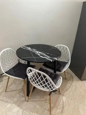 a black table and two chairs and a table and chairs at Appartement chic et cosy en plein centre de Gueliz in Marrakech