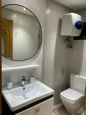 a bathroom with a sink and a toilet and a mirror at Appartement chic et cosy en plein centre de Gueliz in Marrakech