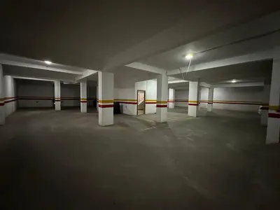 an empty parking lot with white columns in a parking garage at Appartement chic et cosy en plein centre de Gueliz in Marrakech