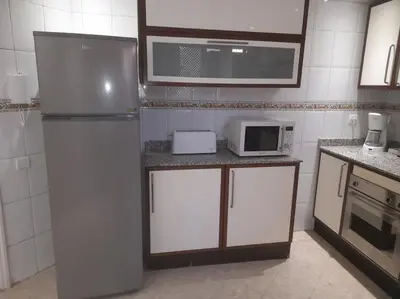 a kitchen with a refrigerator and a microwave at App spacieux marrakech centre ville in Marrakech