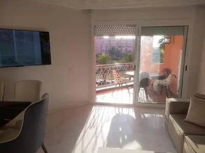 a living room with a view of a balcony at App spacieux marrakech centre ville in Marrakech