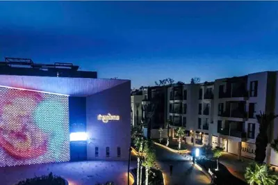 a view of a building with a large screen at night at Appartement moderne au Golf in Marrakech