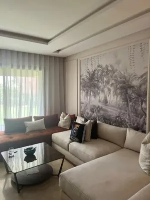 a living room with a couch and a coffee table at Appartement moderne au Golf in Marrakech