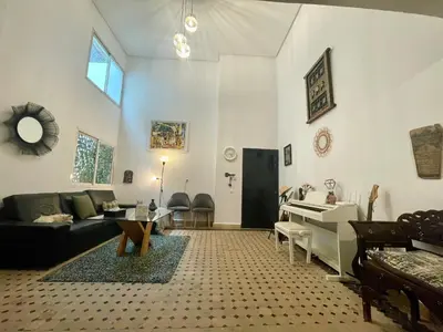 a living room with a couch and a table at Au Riad Des Sultans - Marrakech in Marrakech