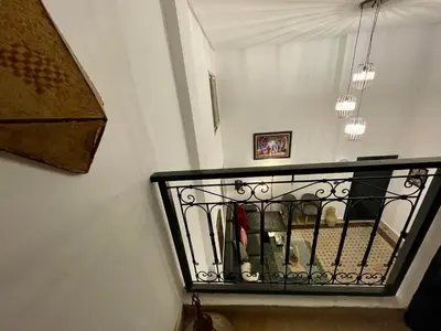 a staircase with a wrought iron railing in a house at Au Riad Des Sultans - Marrakech in Marrakech