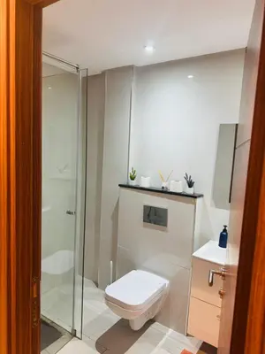 a bathroom with a shower and a toilet and a sink at Superbe appart au centre de gueliz in Marrakech
