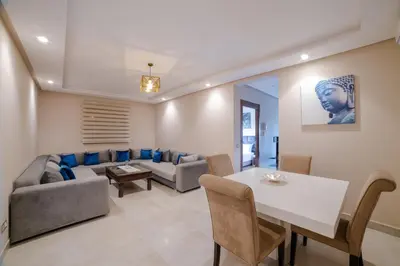 a living room with a couch and a table at Superbe appart au centre de gueliz in Marrakech