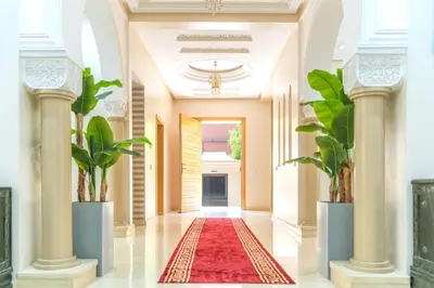a hallway with two columns and a red rug at Peaceful Marrakech Villa 4 Bedrooms Private Pool in Marrakech